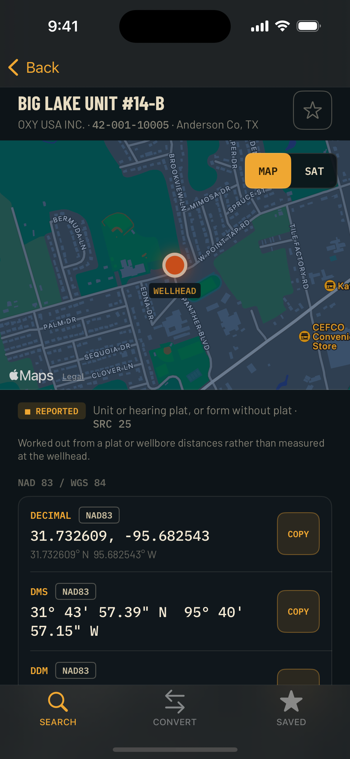 The same PetroCoordinates well detail screen in night mode: warm near-black background, amber labels, the wellhead pin glowing on a dimmed map.